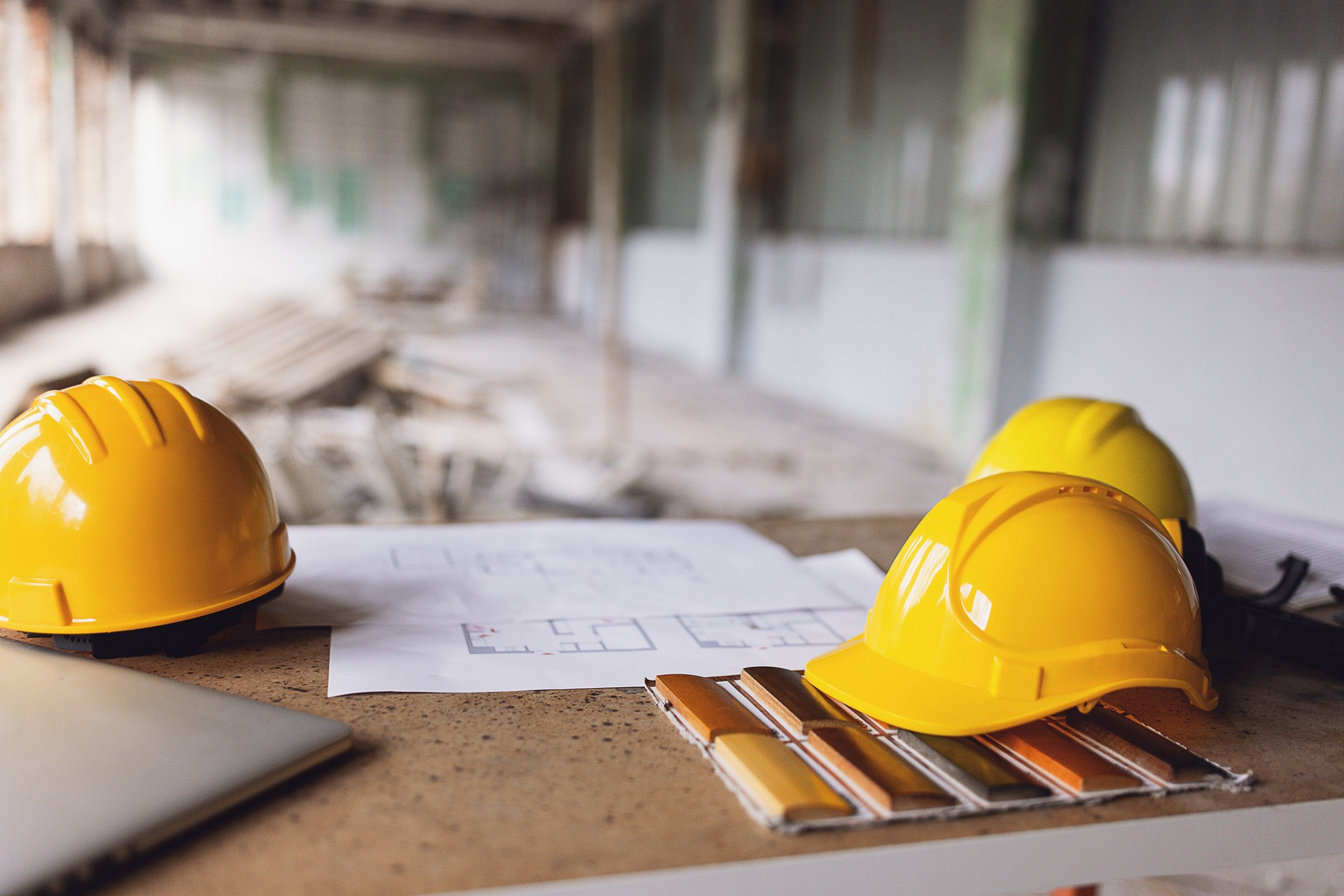 Construction helmets and blueprints on site